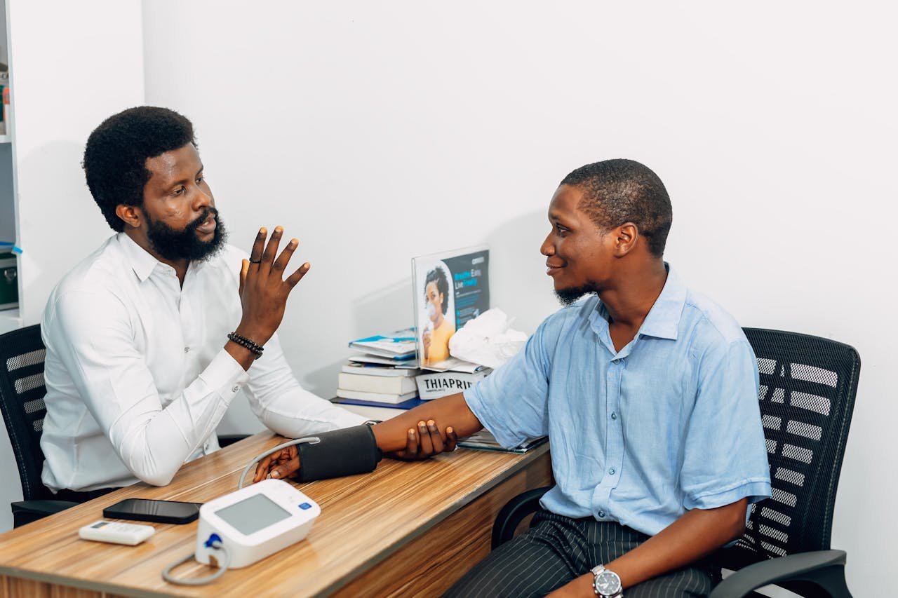 A medical professional consults with a patient during a blood pressure checkup in Lagos, Nigeria.